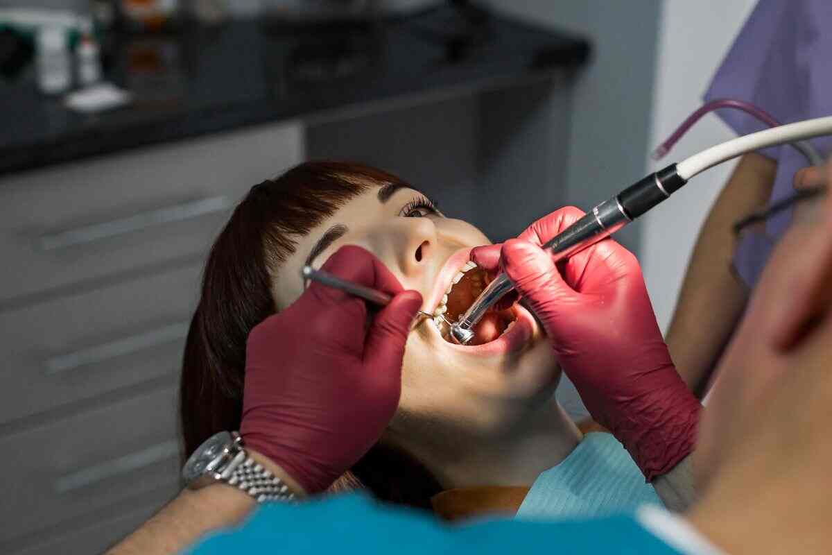 close up of a dentist performing cavity treatment of a woman