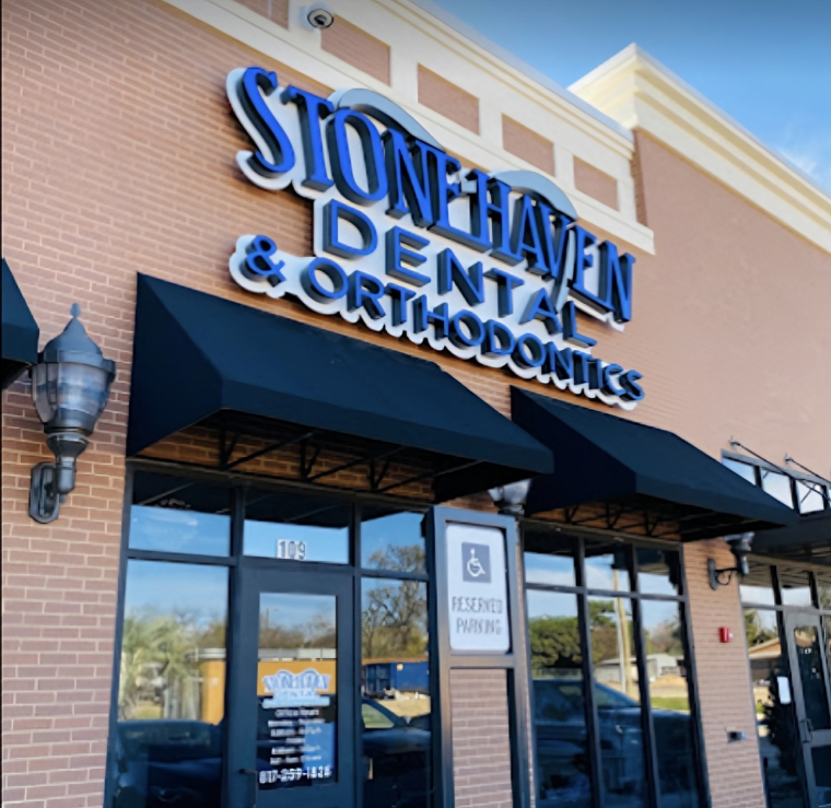 Stonehaven Dental & Orthodontics storefront with blue signage on brick building exterior.