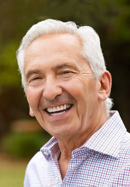 elderly smiling after restoring smiling with quality dental care in Killeen