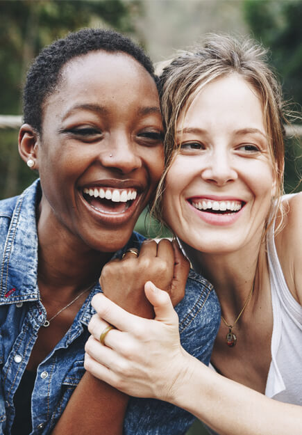 women smiling together after general dental care