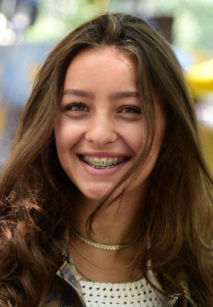 closeup face of smiling girl wearing braces
