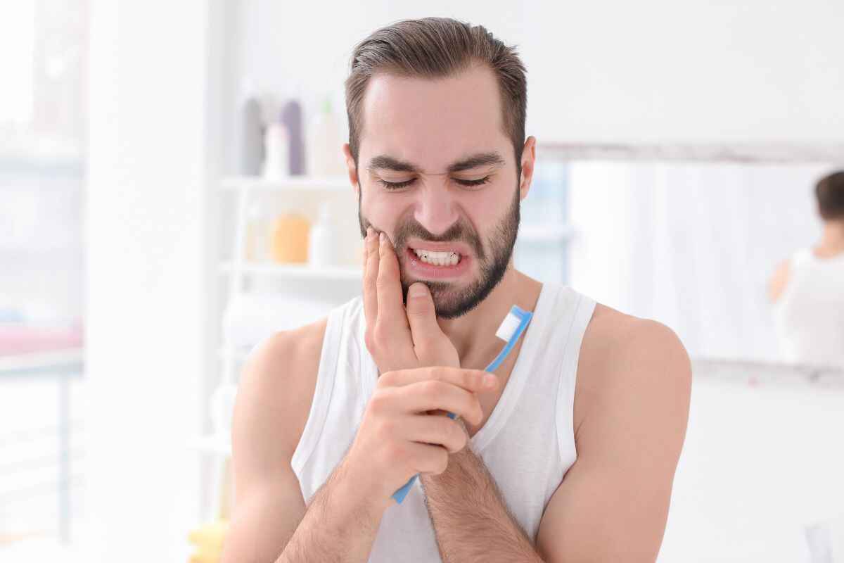 man feels sensitivity when brushing